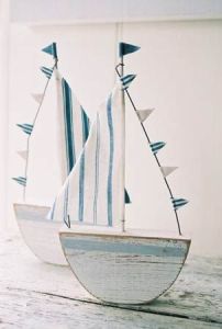 These are NOT on Etsy, but Matt said he'd make one for me. If he makes the base and creates a dowel, I can make a sail with left over fabric from the bunting. This sailboat can sit on the shelf above the change table.